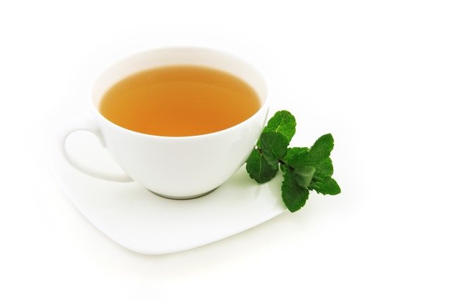 Green tea benefits with herb in cup