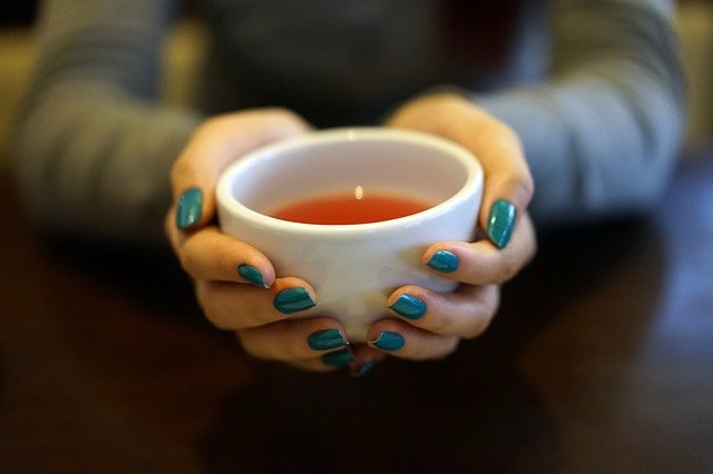 women holding the best herbal tea